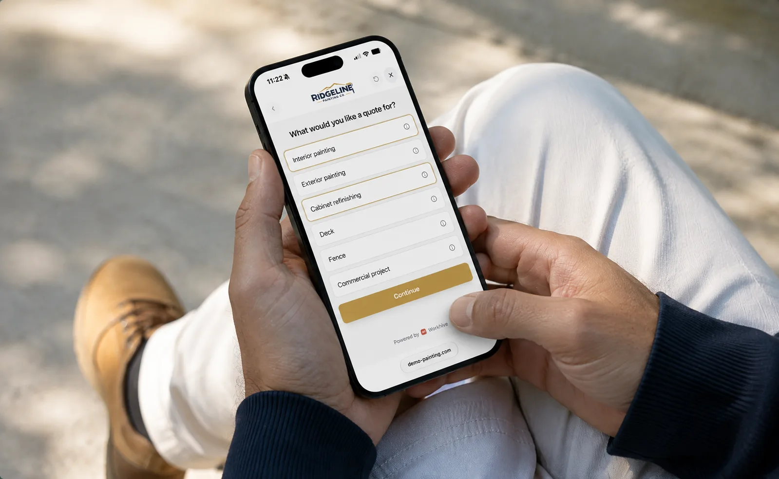 A homeowner sitting outdoors holding a phone, working through a painting company's Instant Ballpark form — interior painting, exterior painting, cabinet refinishing, deck, fence — with a Continue button